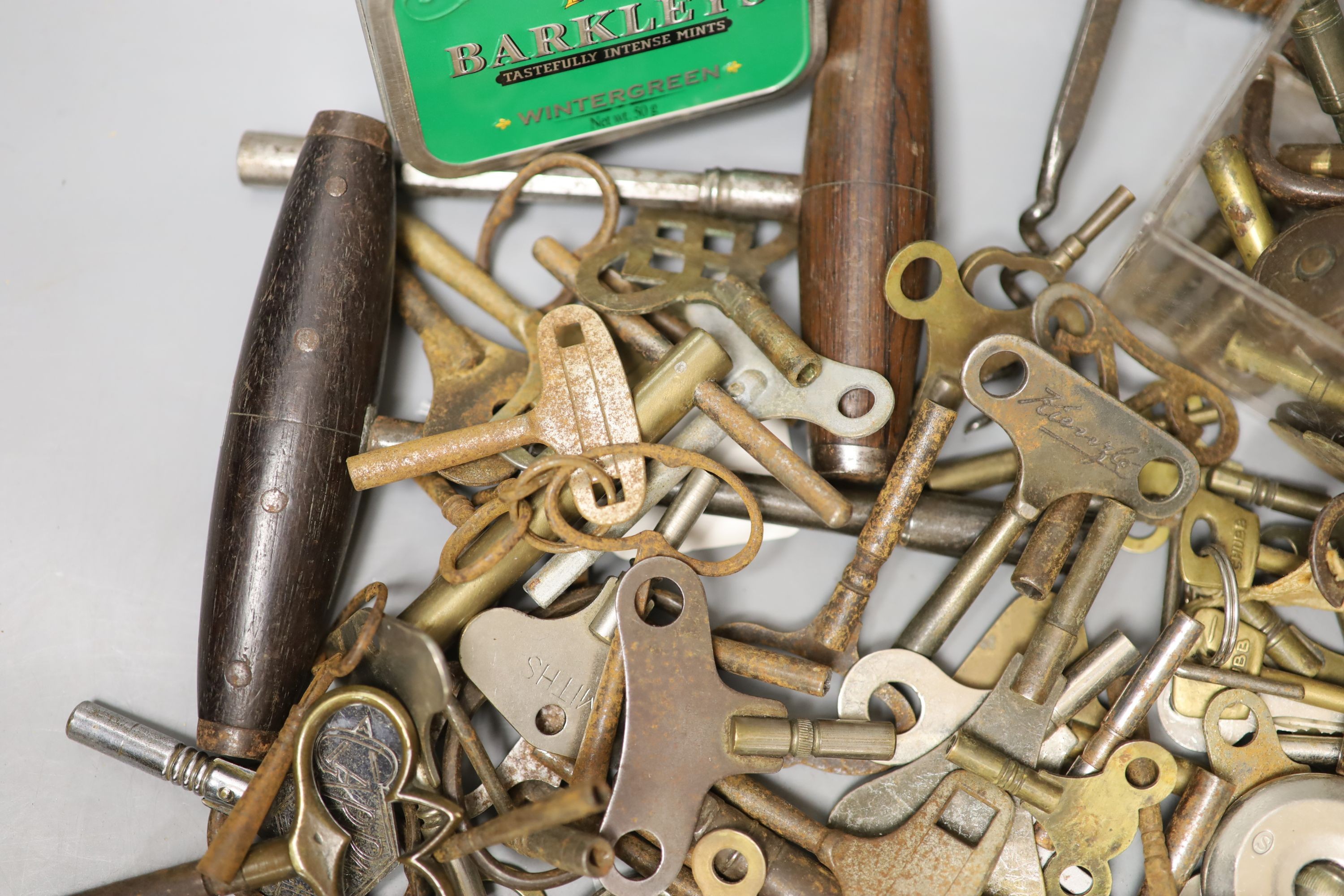 Assorted watch keys and winders and a corkscrew